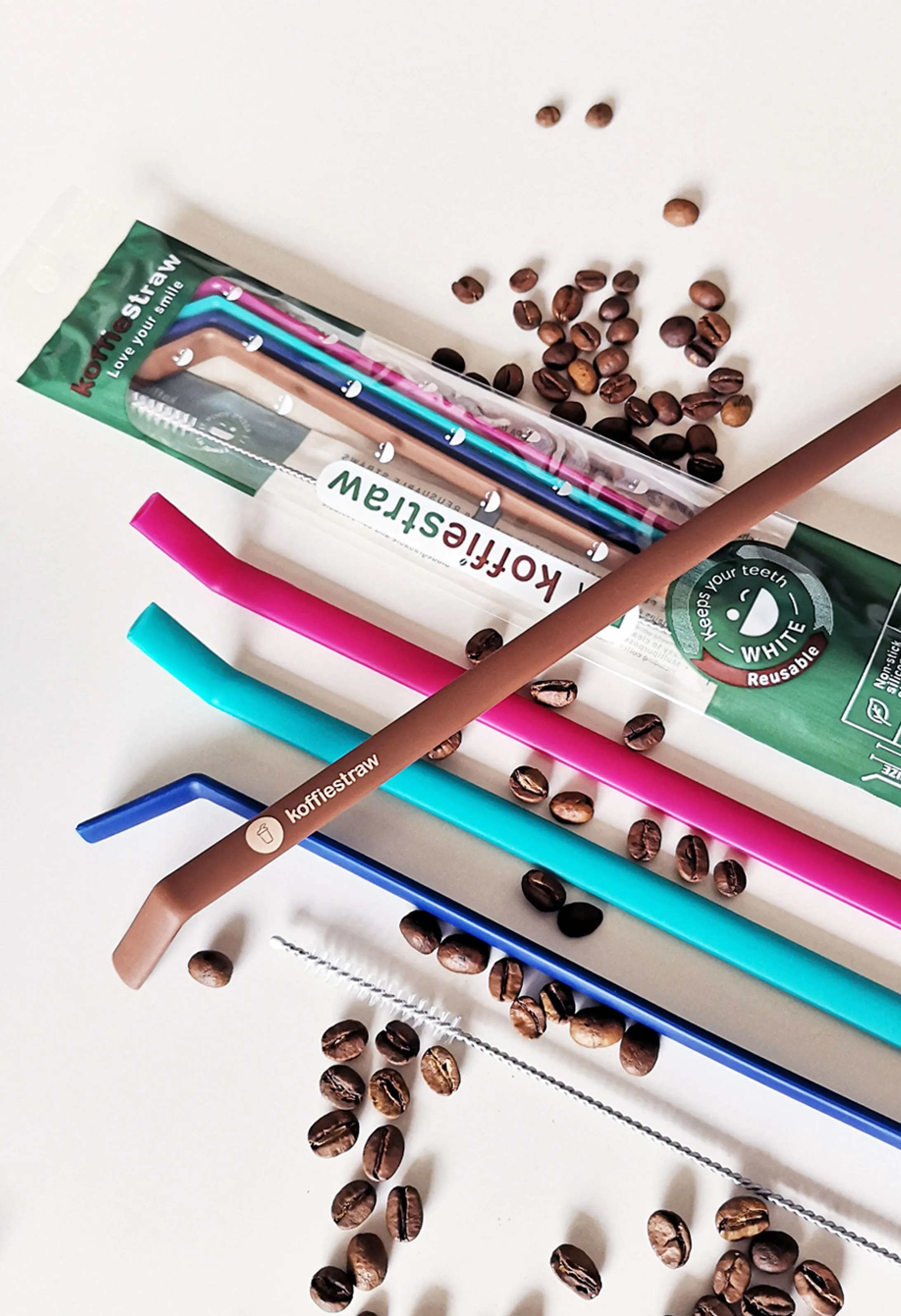 4-Pack of KoffieStraw 8": Mocha, Navy, Plum, Surf with stainless steel cleaning brush in a home compostable packaging