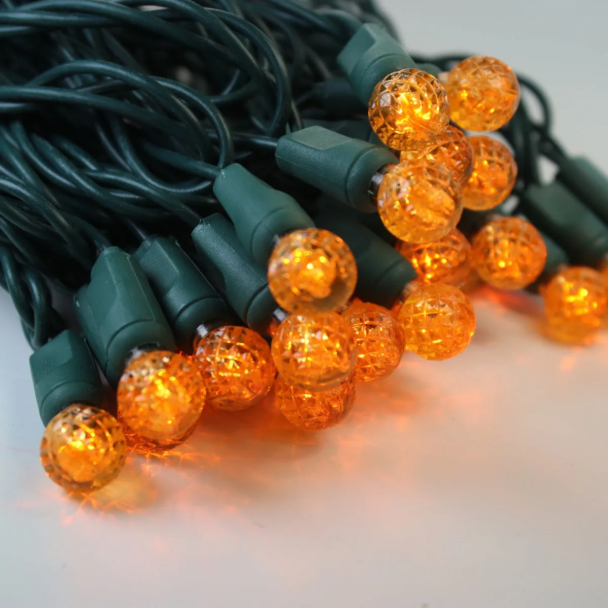 50-light  G12 Orange LED Christmas Lights, 4" Spacing Green Wire